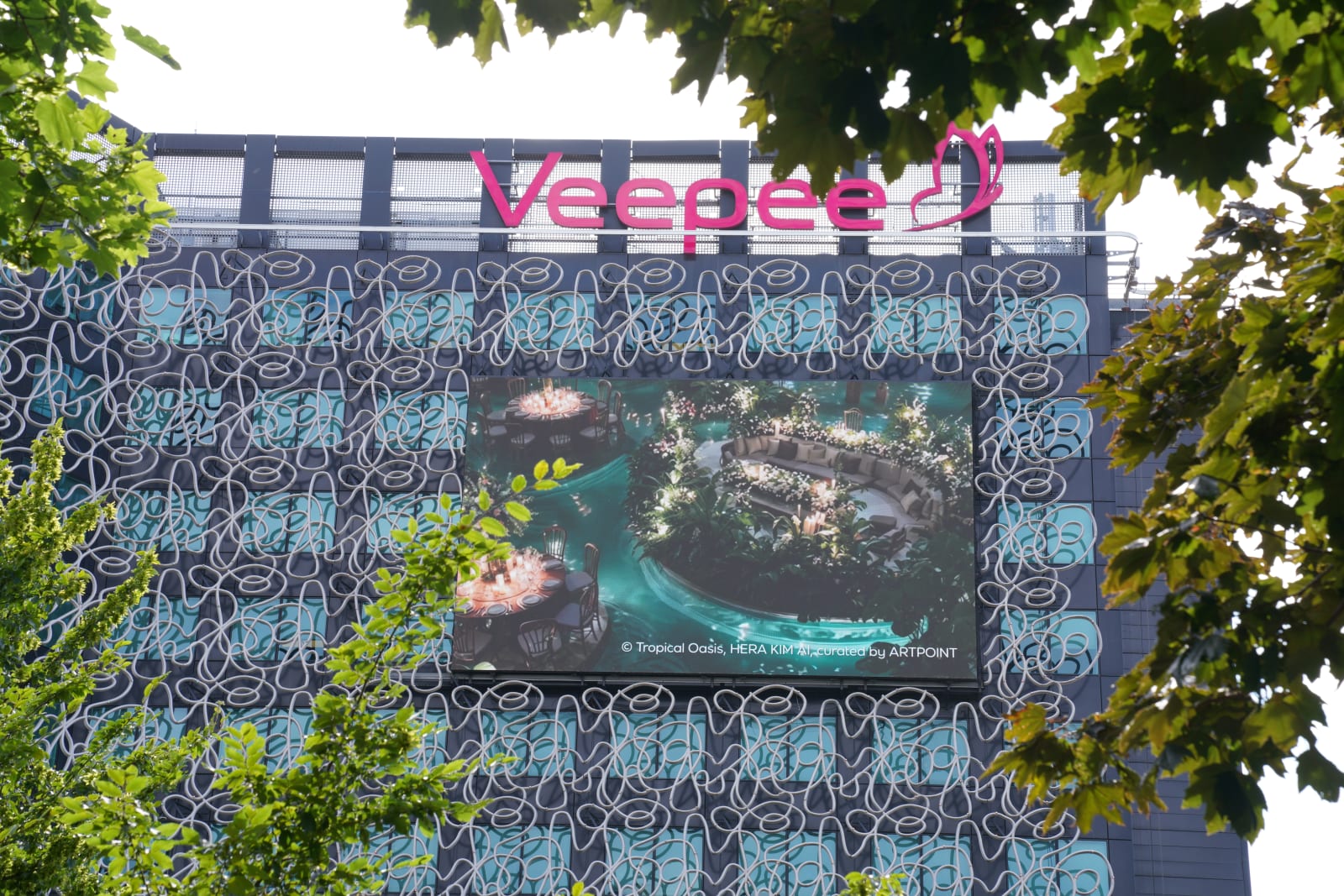 VEEPEE screen showing garden artwork through surrounding trees